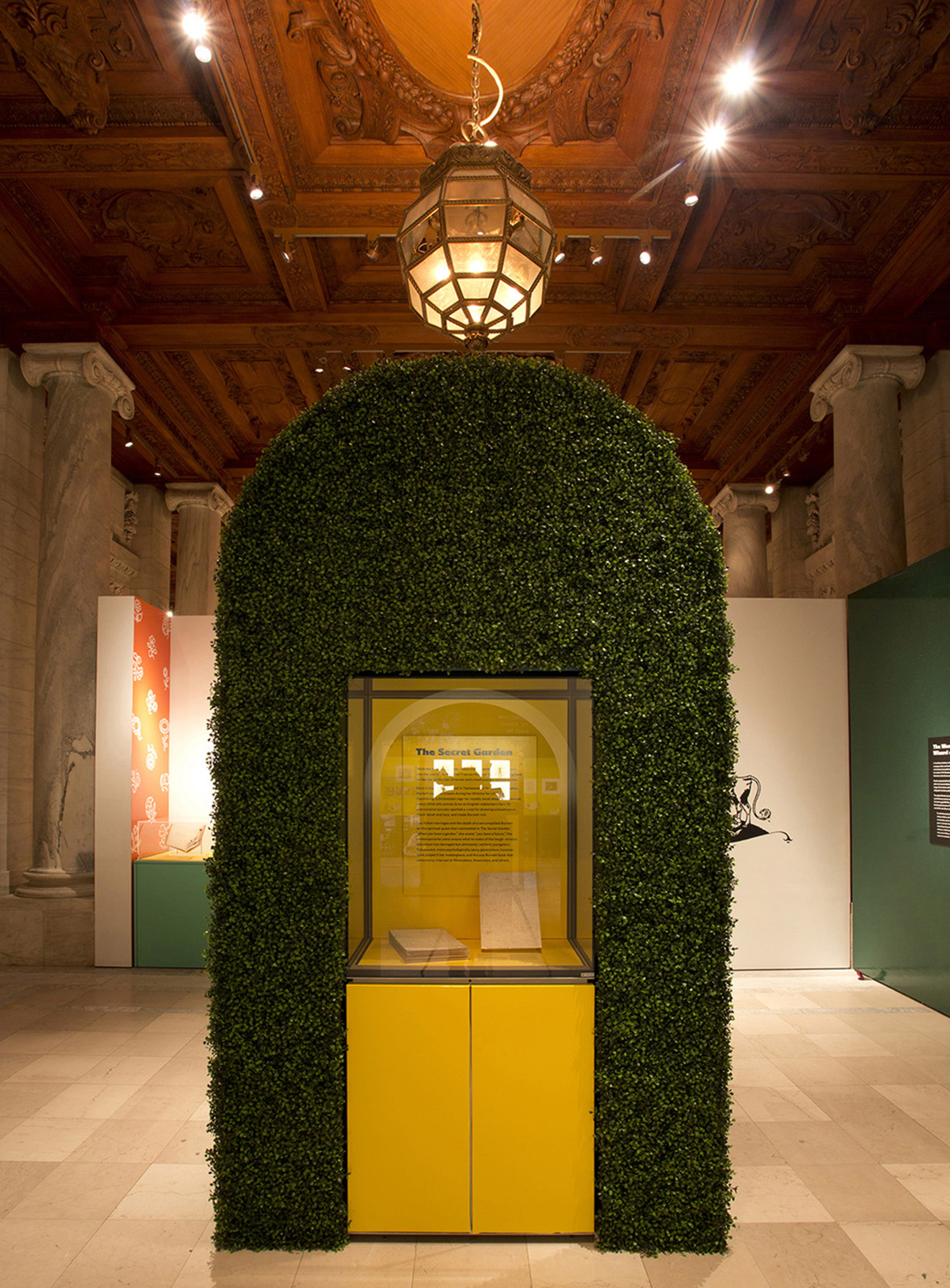 ABC of It. Another example of tactility and respite in the exhibition: additional seating and available books created a reading space for visitors. Here, the complete manuscript of The Secret Garden is displayed on a repurposed display core.