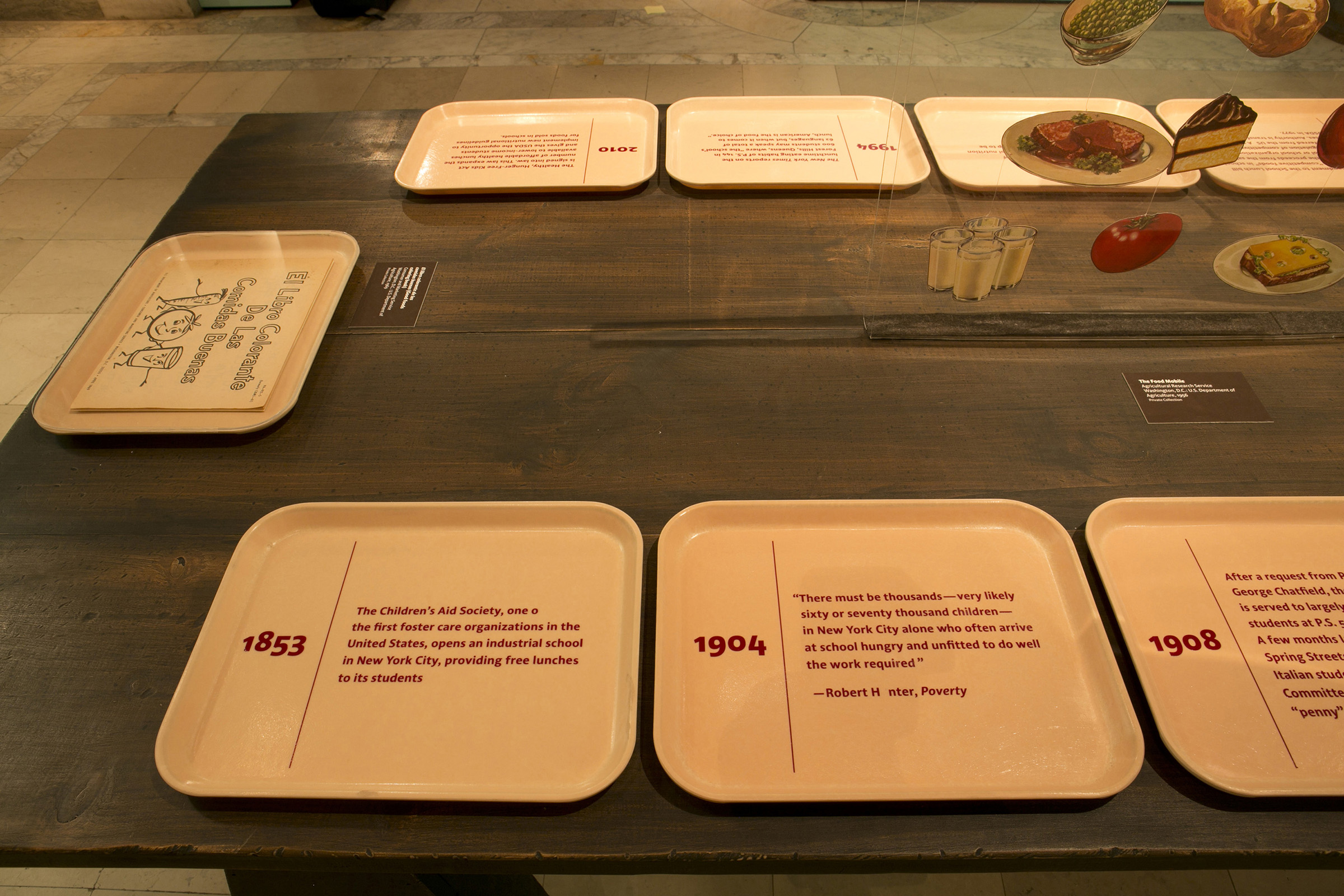 Lunch Hour - A timeline of charitable meals for children was displayed on lunch trays.