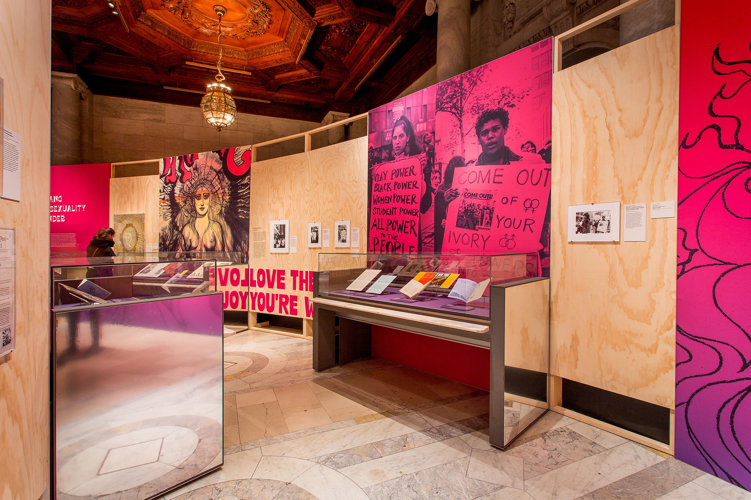 You Say You Want A Revolution - “Sexuality and Gender” section, showing large fabric prints behind artifact cases.