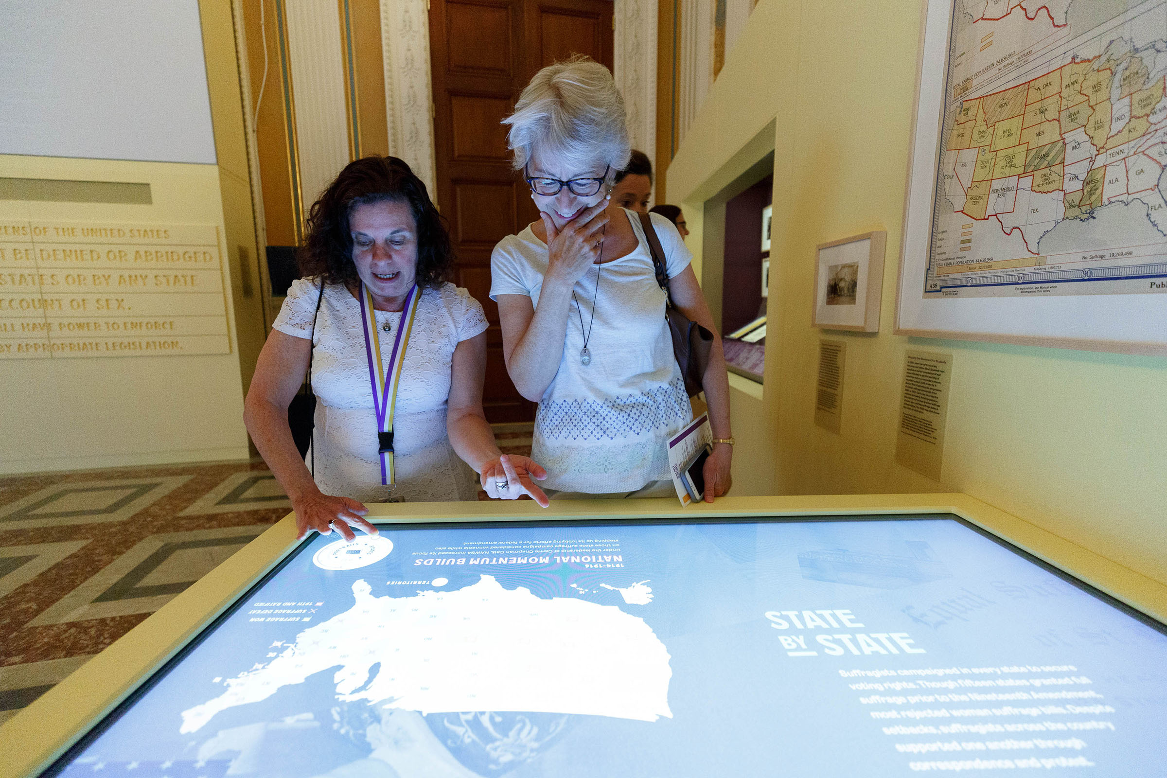 Shall Not Be Denied Exhibition Opening. Visitors use a digital interactive table to explore the contributions of suffragists from all 50 states. (Upswell designed the user interaction and worked with the LOC team to organize the content.)